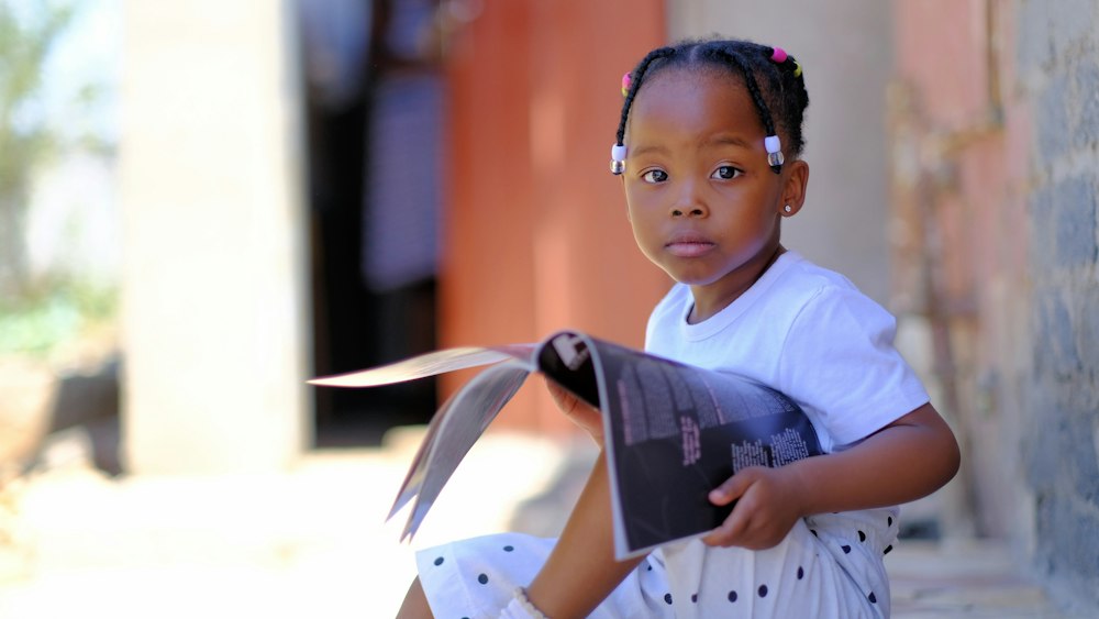 A young girl holding a book
