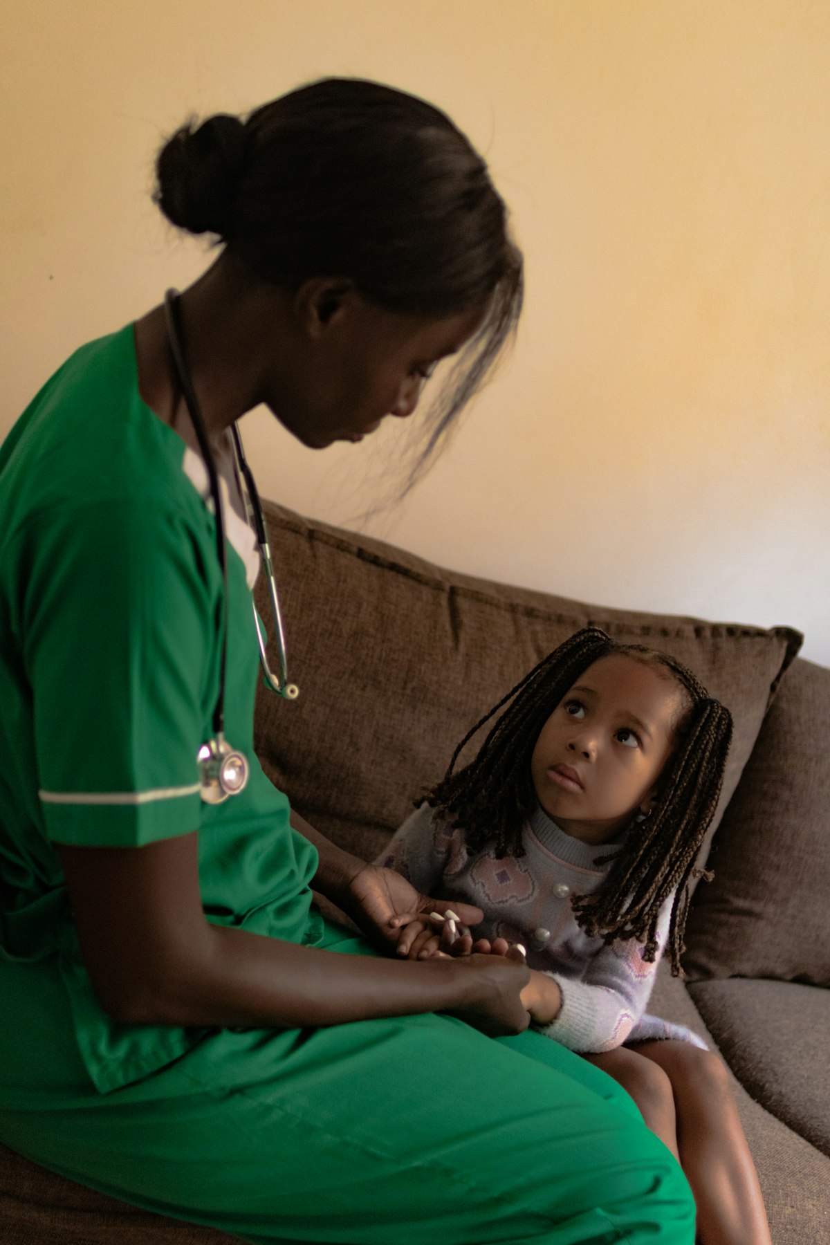Nurse attending to a young child in the sick bay